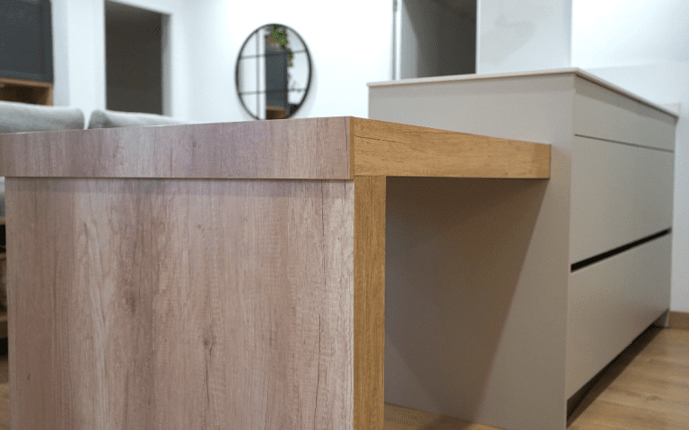 Cocina abierta con zona de comedor y tonos neutros